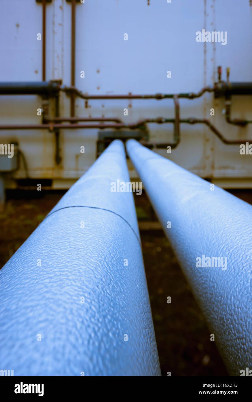 Detail of two pipes running parallel to the wall of a Power Plant, St