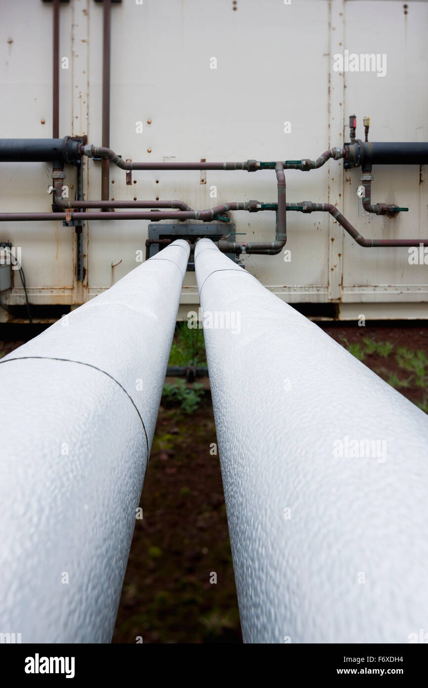 Detail of two pipes running parallel to the wall of a Power Plant, St
