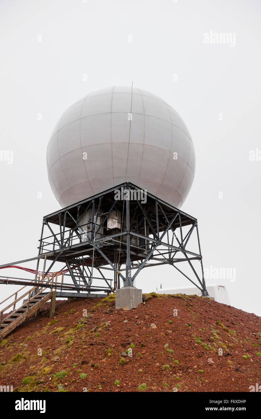 A radar dome sits atop a red dirt hill, St. Paul Island, Southwestern Alaska, USA, Summer Stock