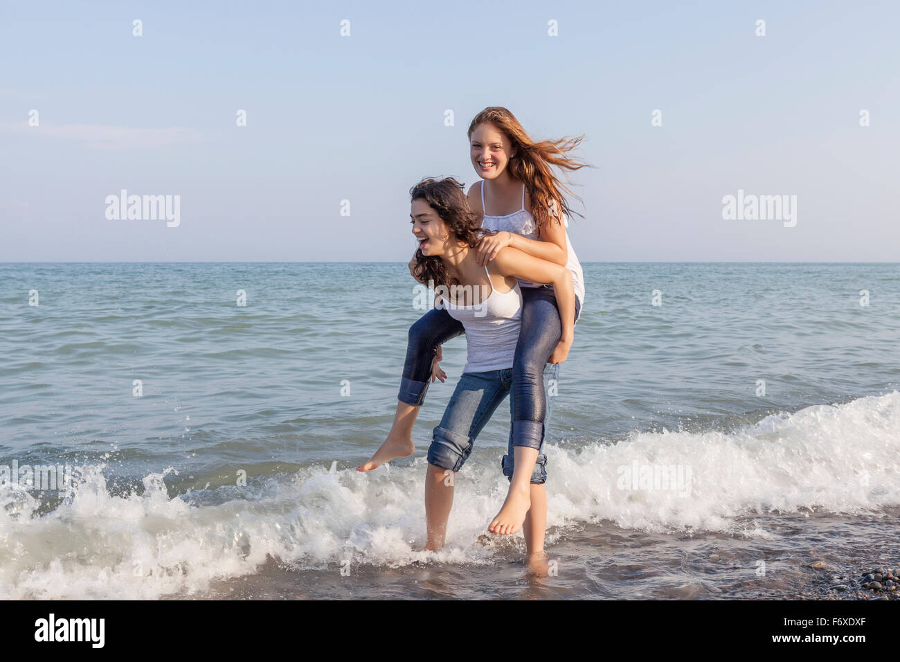 Two girls playing piggyback at beach; Toronto, Ontario, Canada Stock ...