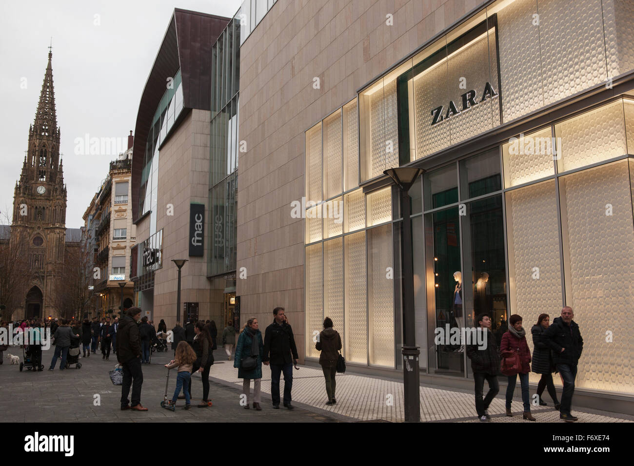 Shoppers in the commercial district of the city centre next to a branch of  Zara with the cathedral spire behind; San Sebastian, Spain Stock Photo -  Alamy