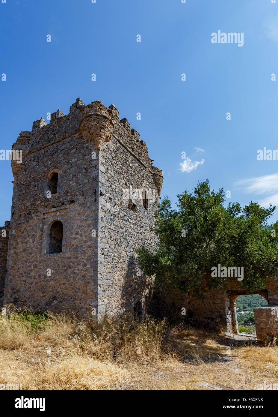 Old picturesque abandoned medieval tower at Messinian Mani in Greece against a blue sky Stock Photo