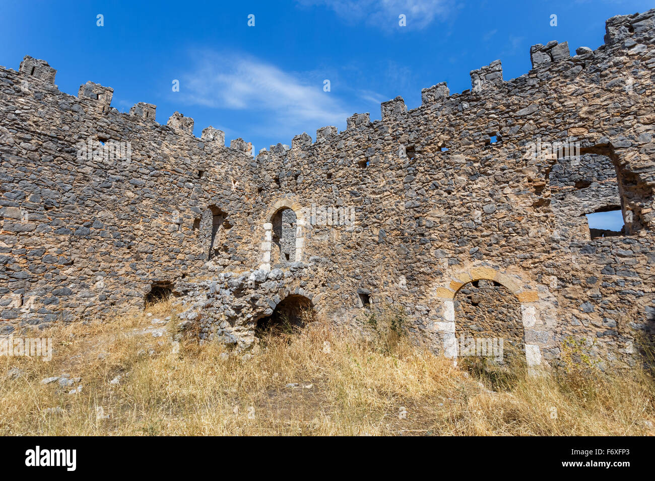 Old picturesque abandoned medieval tower at Messinian Mani in Greece against a blue sky Stock Photo
