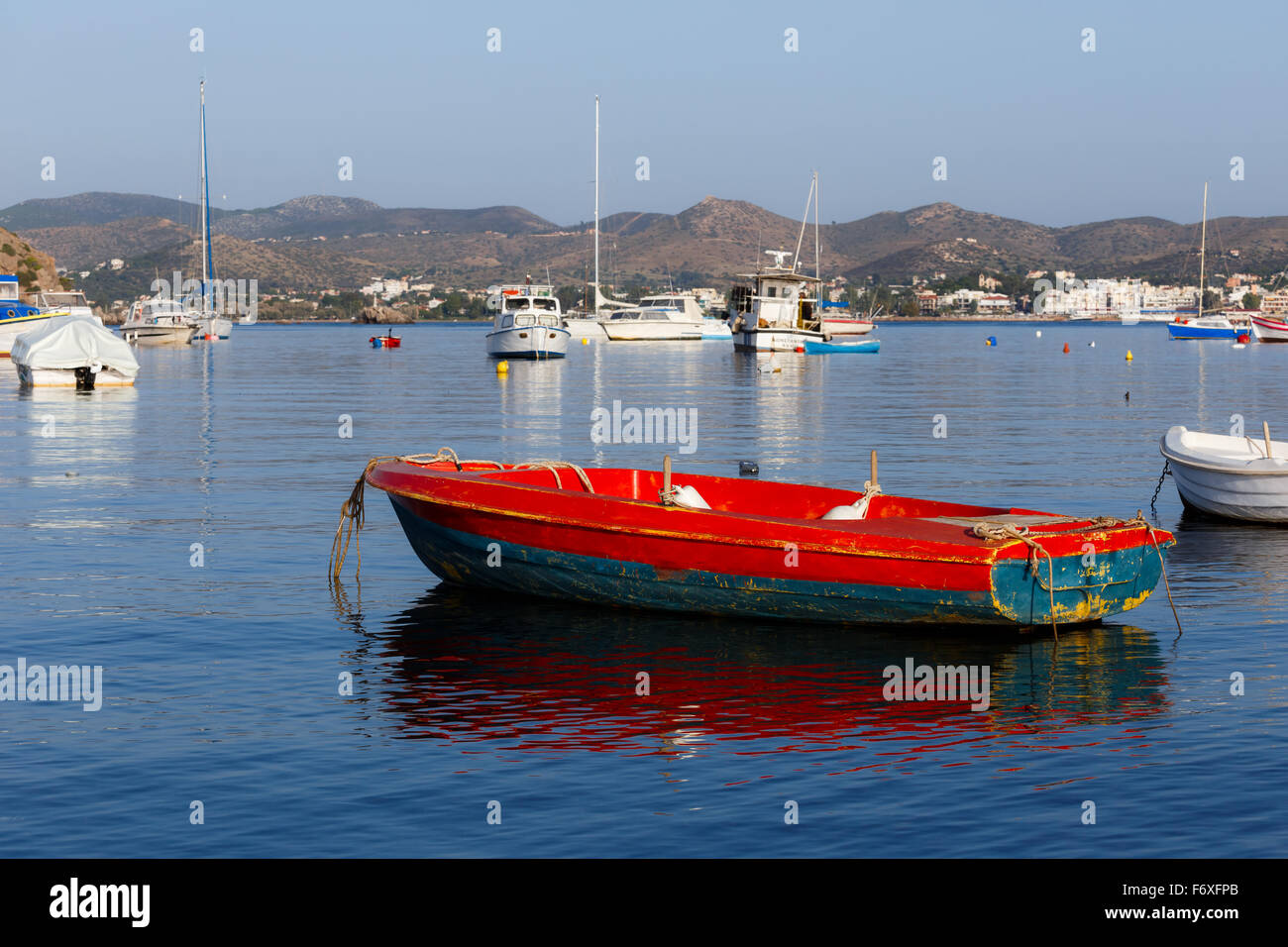 Traditional small fish boats in the afternoon against a blue sky in Greece Stock Photo