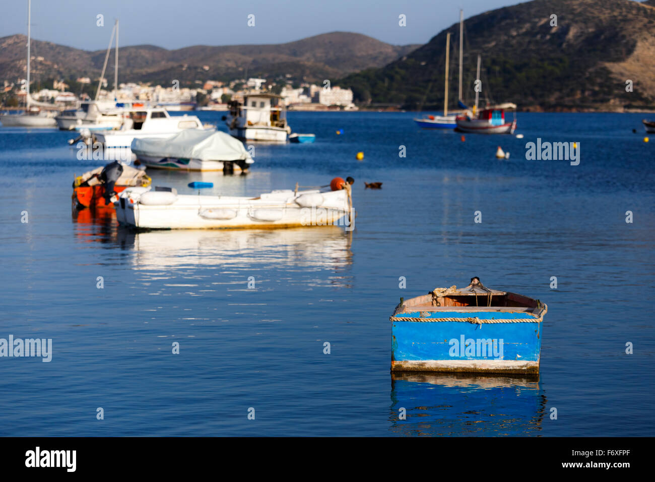 Traditional small fish boats in the afternoon against a blue sky in Greece Stock Photo