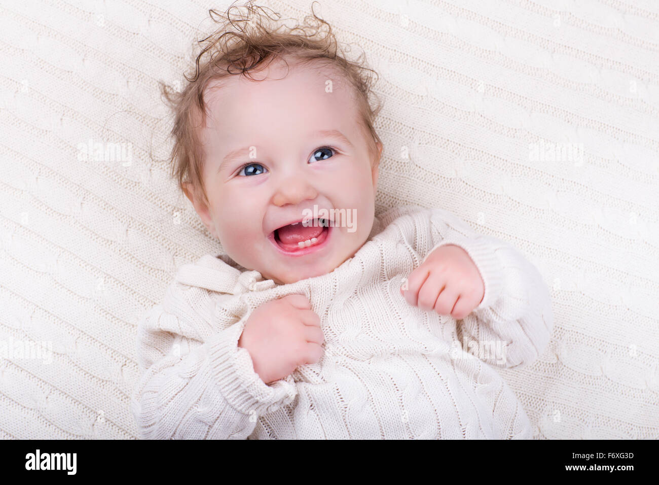 Newborn baby boy in bed. New born child sleeping under a blue knitted