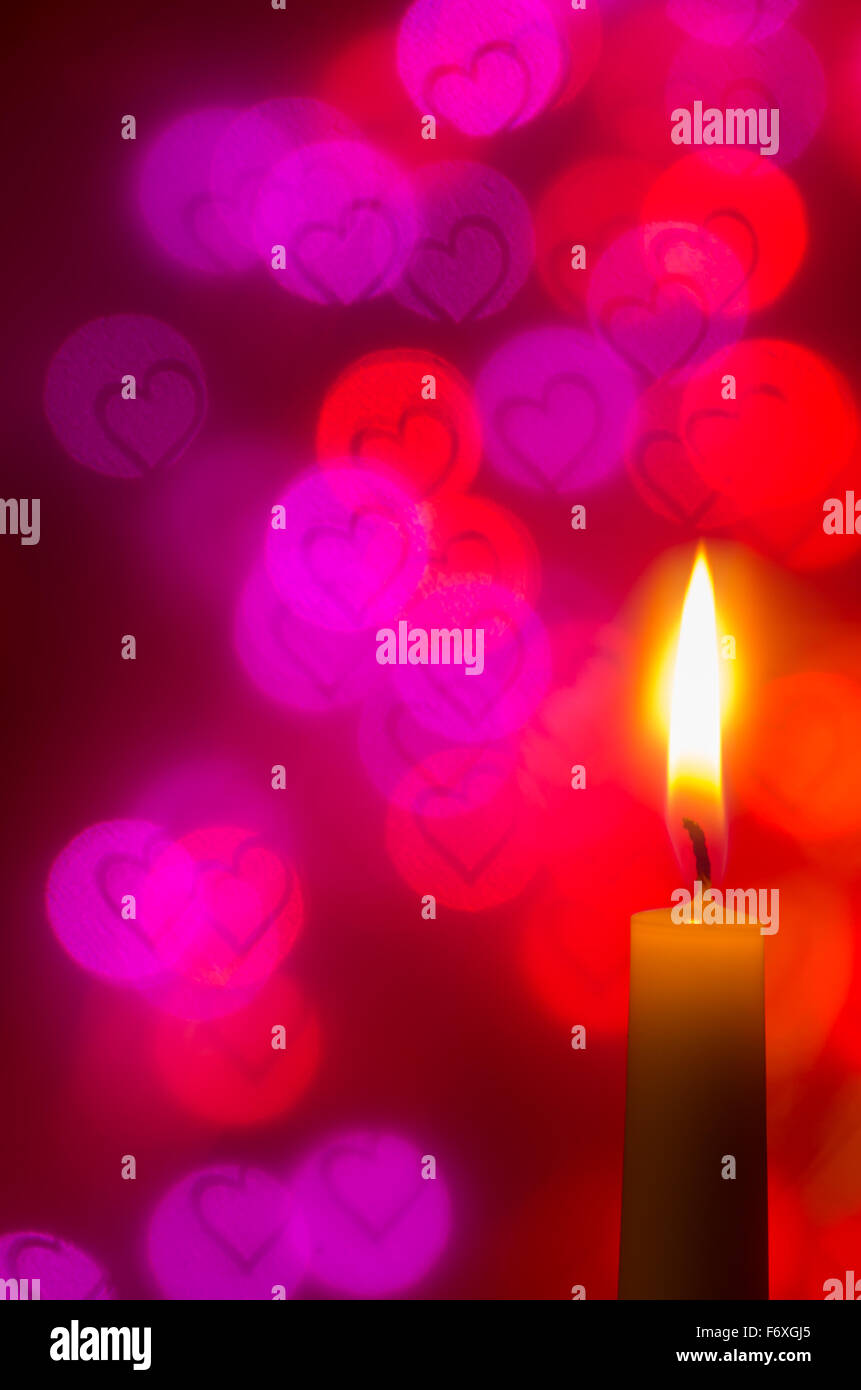 candle on bokeh heart shapes background Stock Photo