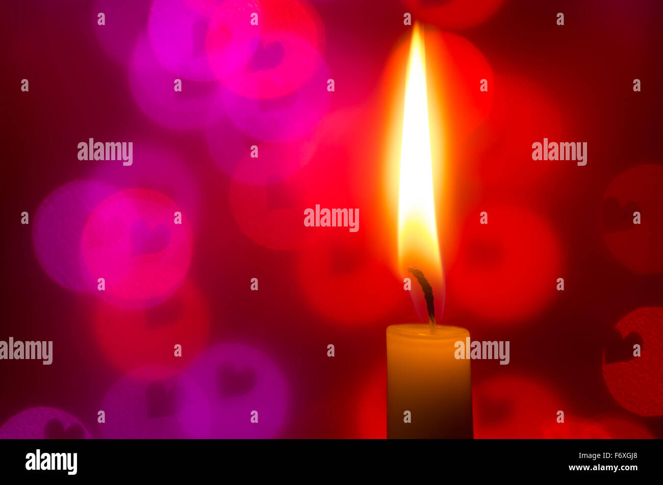 candle on bokeh heart shapes background Stock Photo