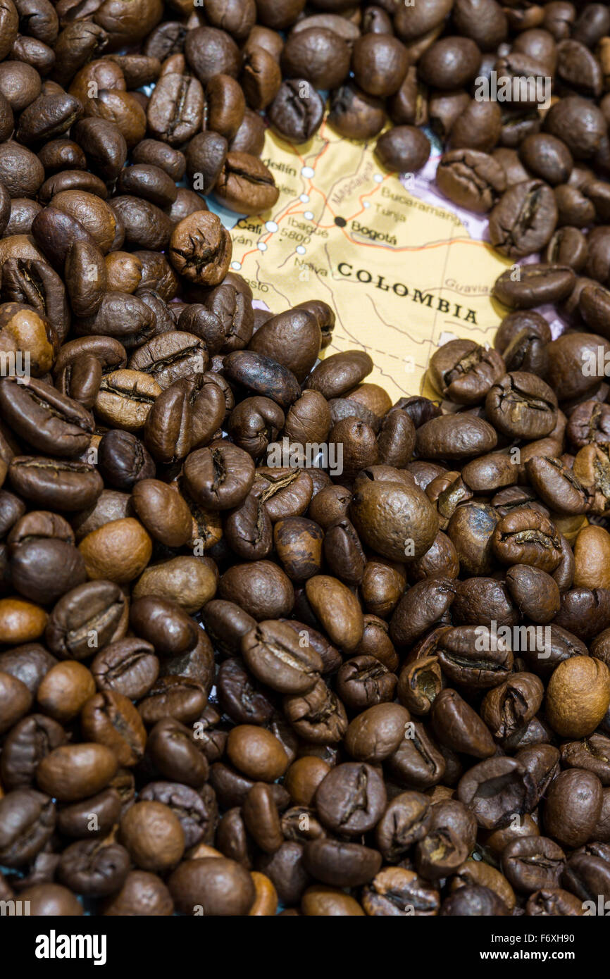 Geographical map of Colombia covered by a background of roasted coffee beans. This nation is the third main producers and export Stock Photo