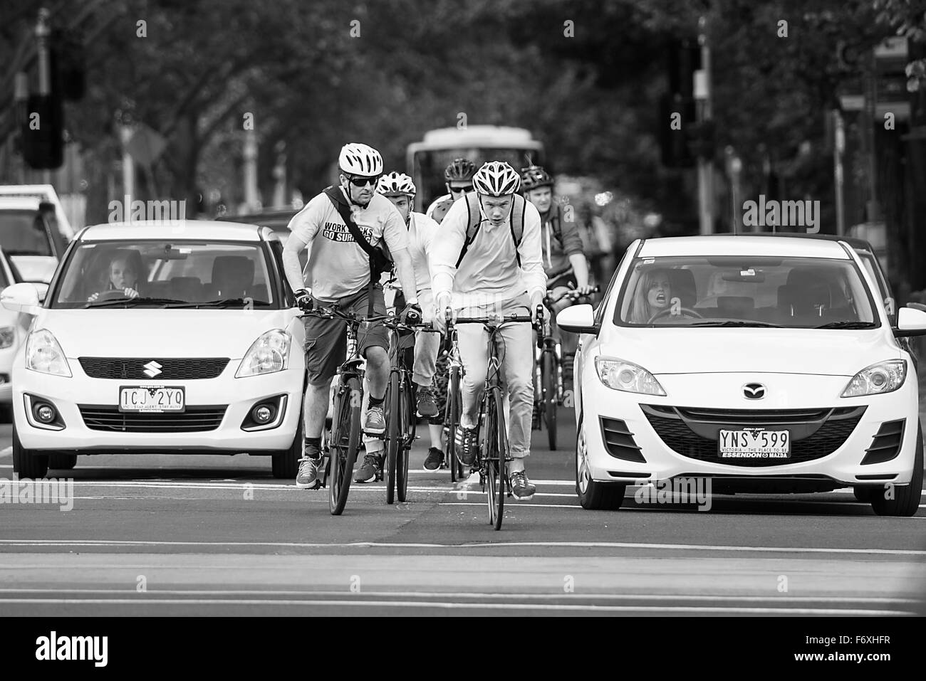 Cyclists on St Kilda Road, Melbourne competing for road space with traffic. Stock Photo