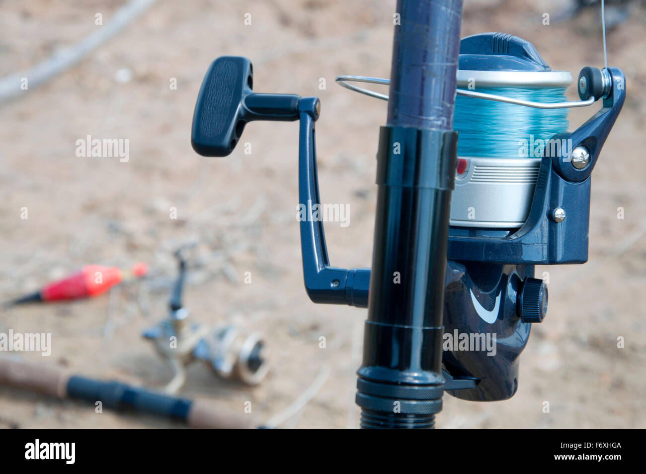 Reel with thread in a fishing rod Stock Photo - Alamy