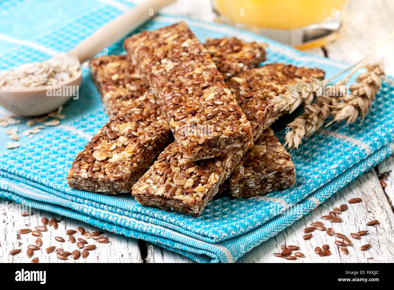 cereal bars, oatmeal, flax seeds and orange juice on a wooden