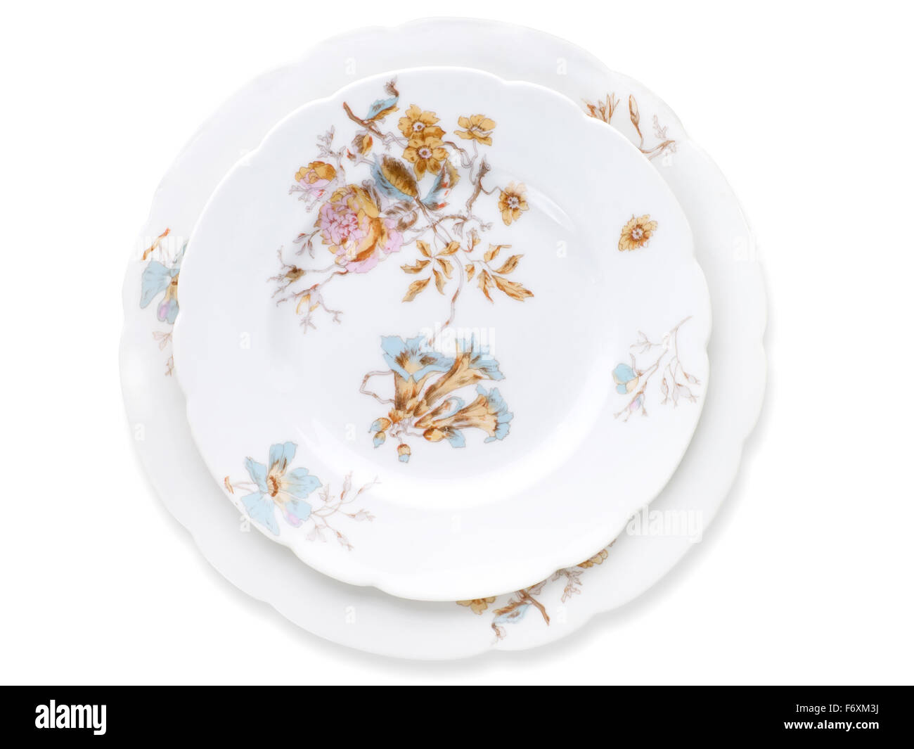 Antique decorated porcelain plates isolated on white with clipping path. Porcelain factory of Kornilov brothers, end of 19th cen Stock Photo