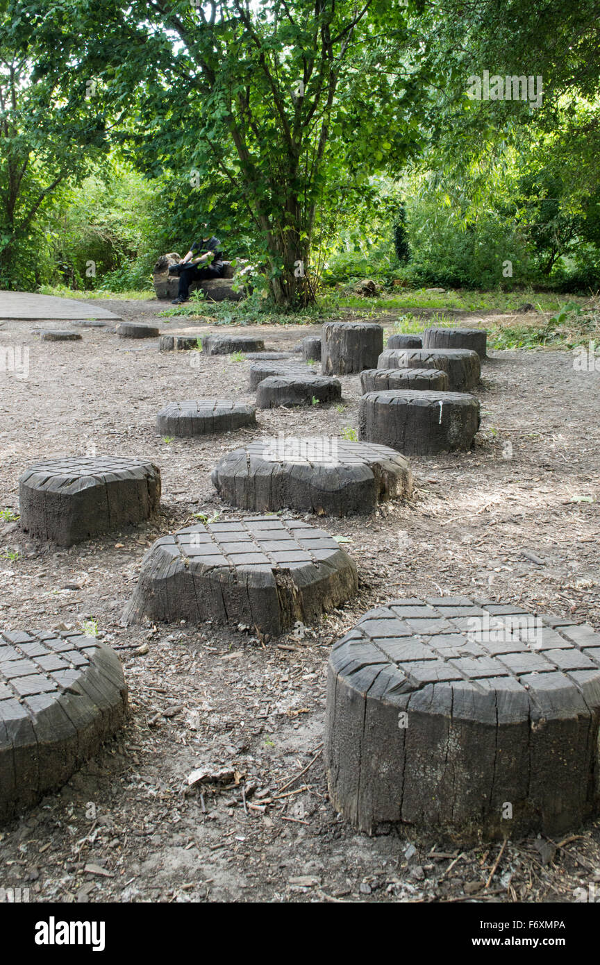 Wooden stepping stumps in a park Stock Photo - Alamy