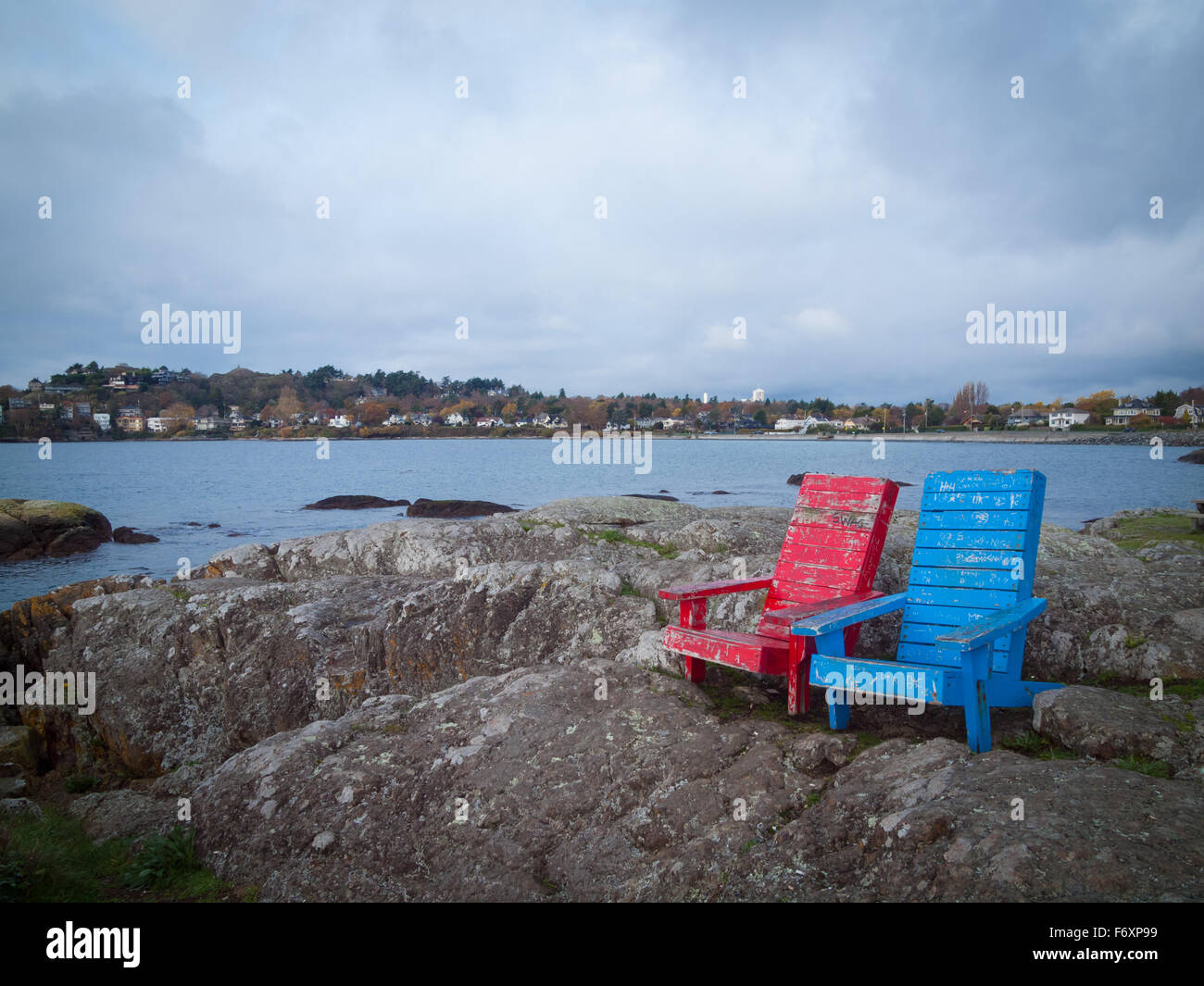 Weathered deck chairs on Kitty Islet, a small waterfront natural area located in McNeill Bay, Oak Bay, Victoria, Canada. Stock Photo