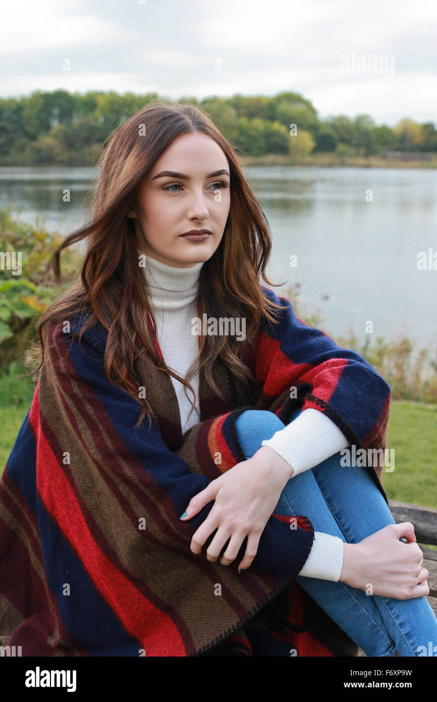portrait of a beautiful girl with long brown hair with hair blowing in ...