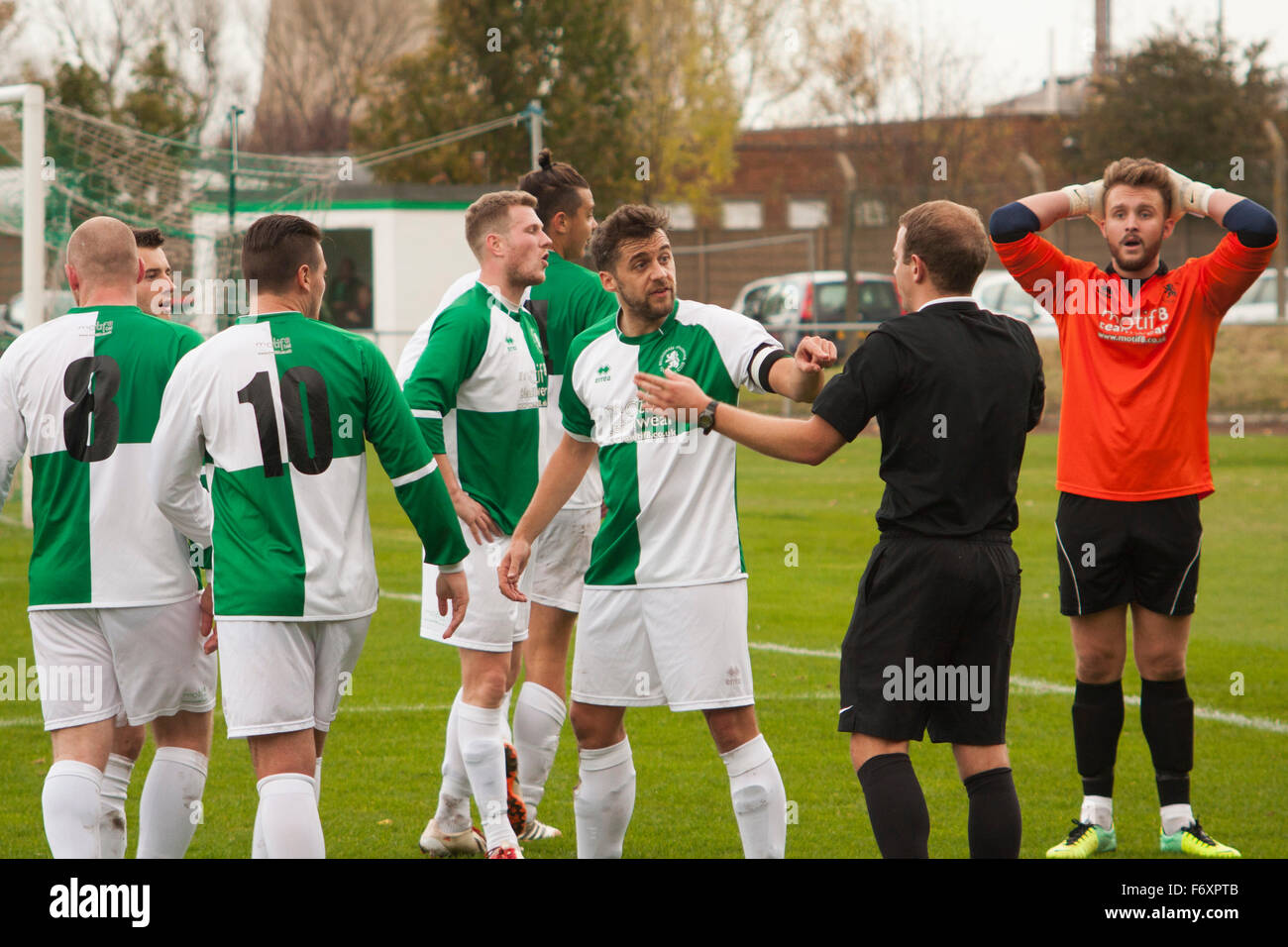 Football players argue at referee hires stock photography and images