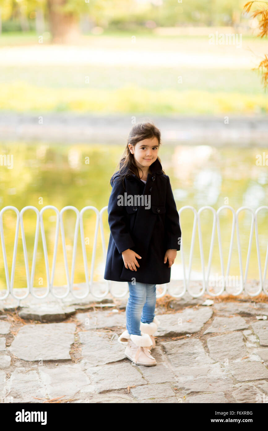 Little girl in the autumn park Stock Photo - Alamy