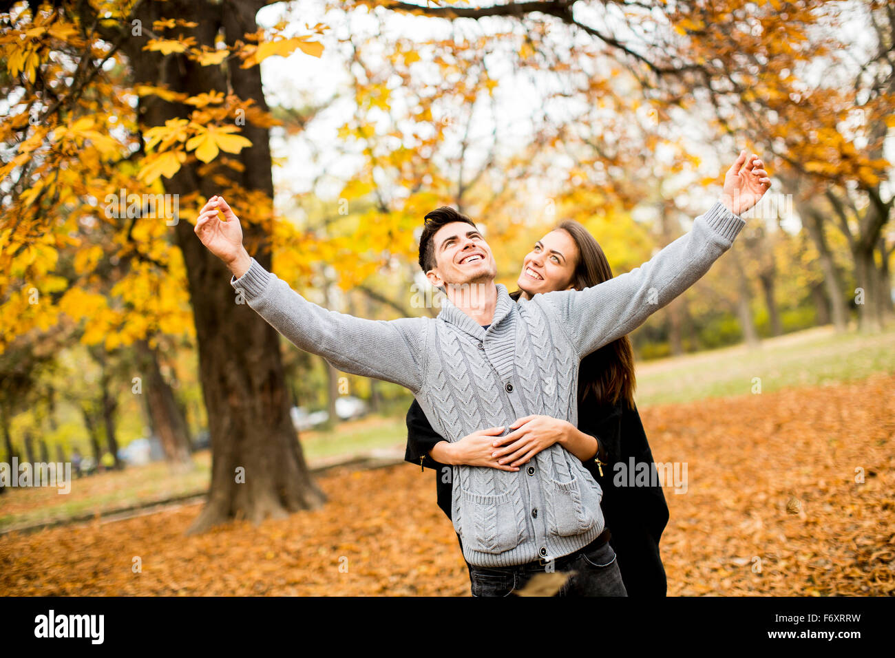 Young couple in the autumn park Stock Photo - Alamy