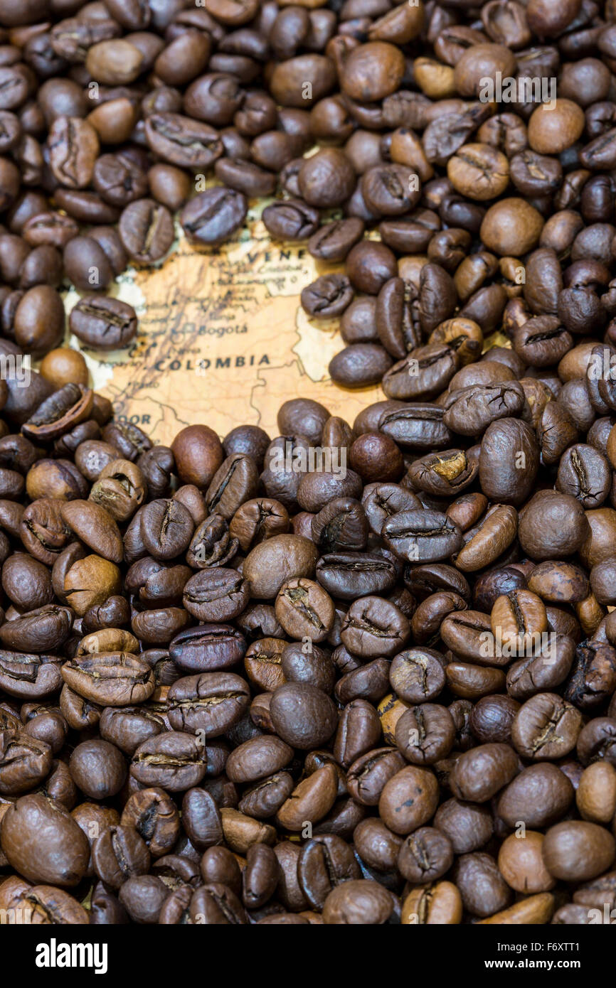 Vintage map of Colombia covered by a background of roasted coffee beans. This nation is the third main producer and exporter of Stock Photo