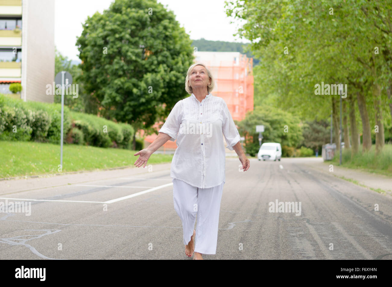 Woman walking barefoot street hi-res stock photography and images - Alamy
