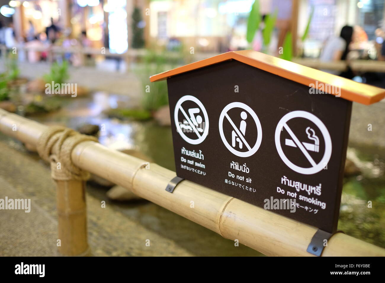 Prohibit sign post on the bamboo fence Stock Photo