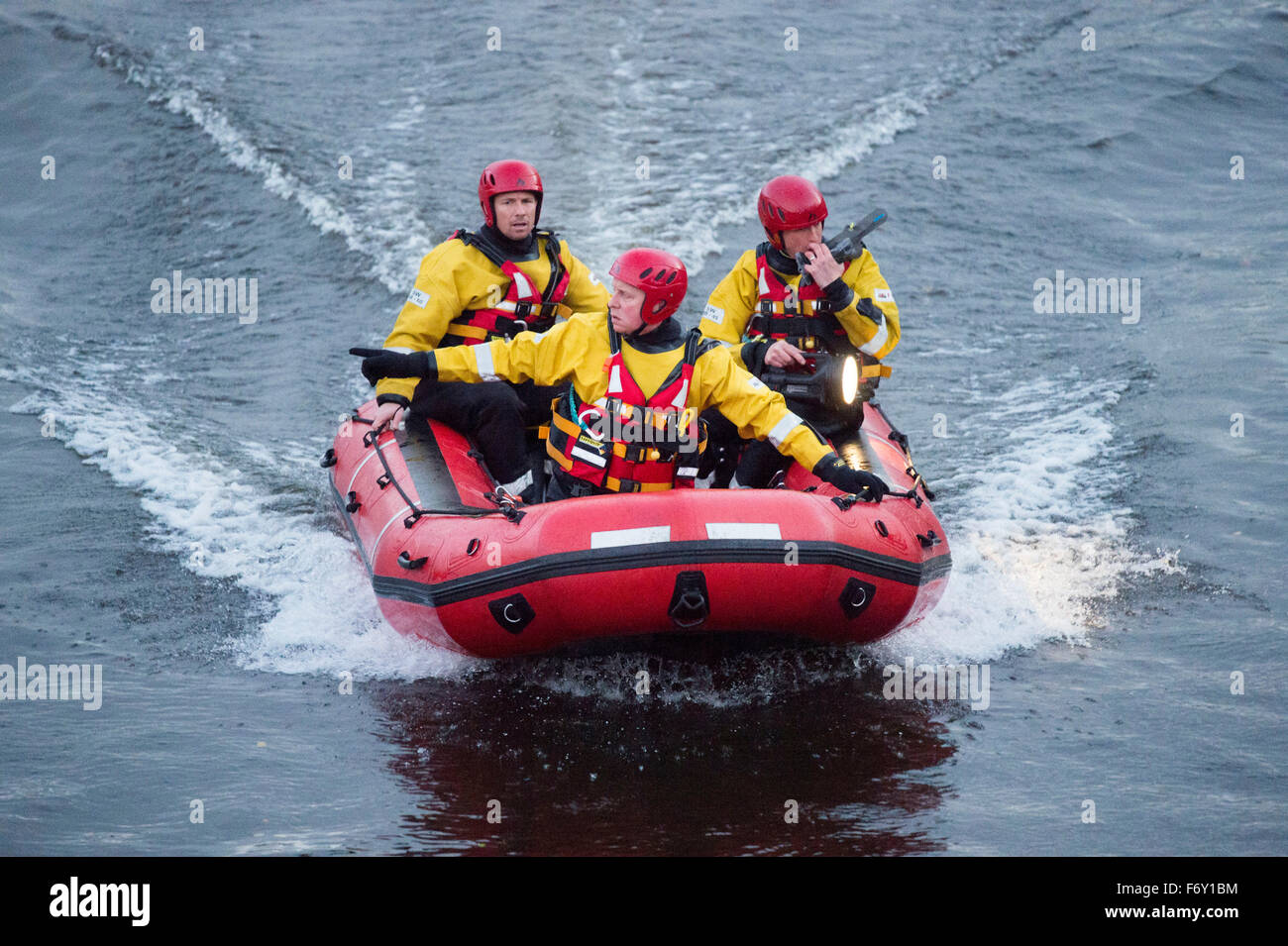 A South Wales Fire and Rescue team use a speed boat to search for a person seen entering the River Taff in Cardiff, South Wales. Stock Photo