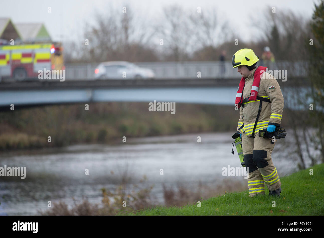 Rescue workers walk along he banks of the River Taff in Cardiff, South Wales, after reports of a body in the water. Stock Photo