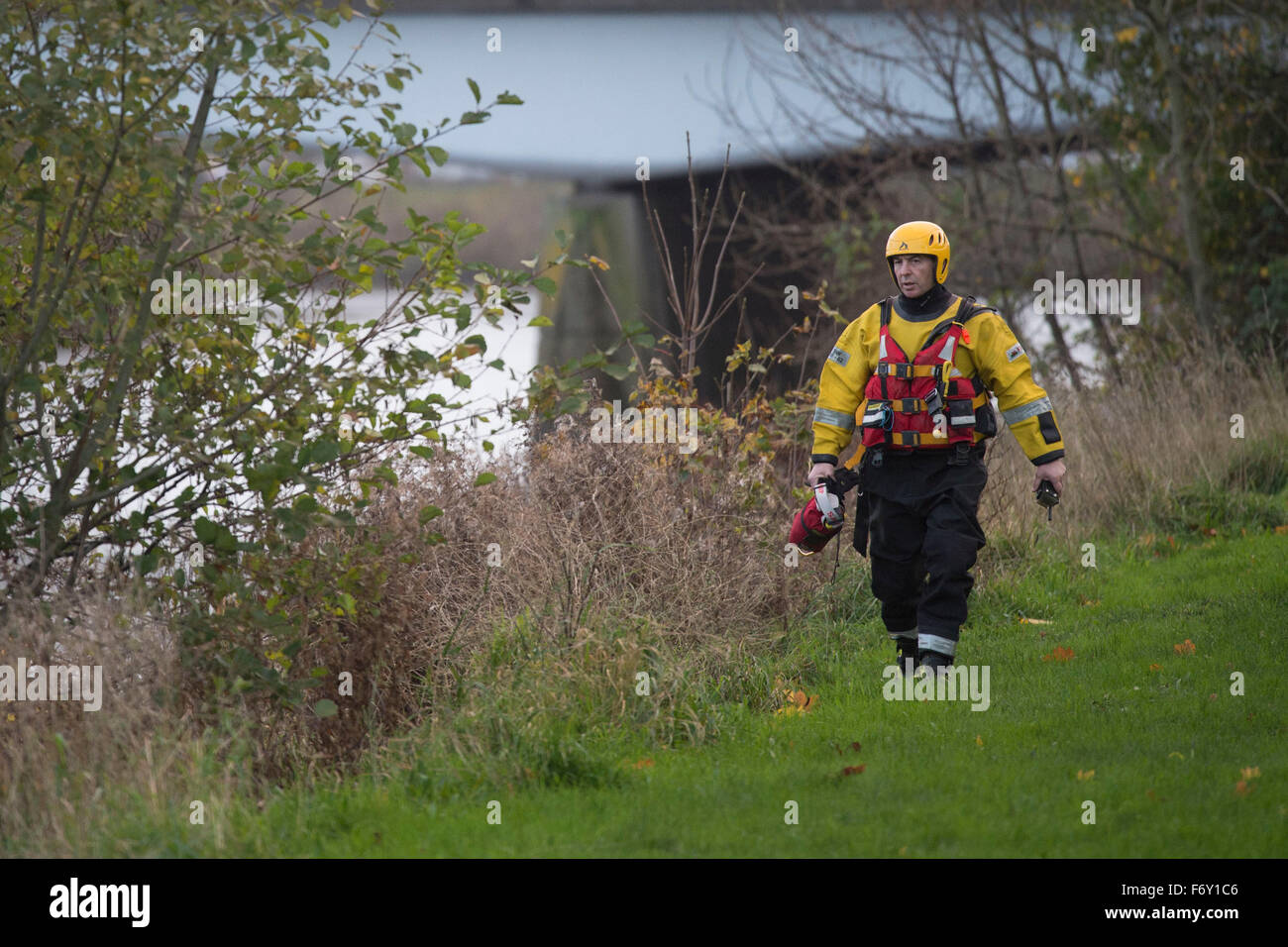 Rescue workers walk along he banks of the River Taff in Cardiff, South Wales, after reports of a body in the water. Stock Photo