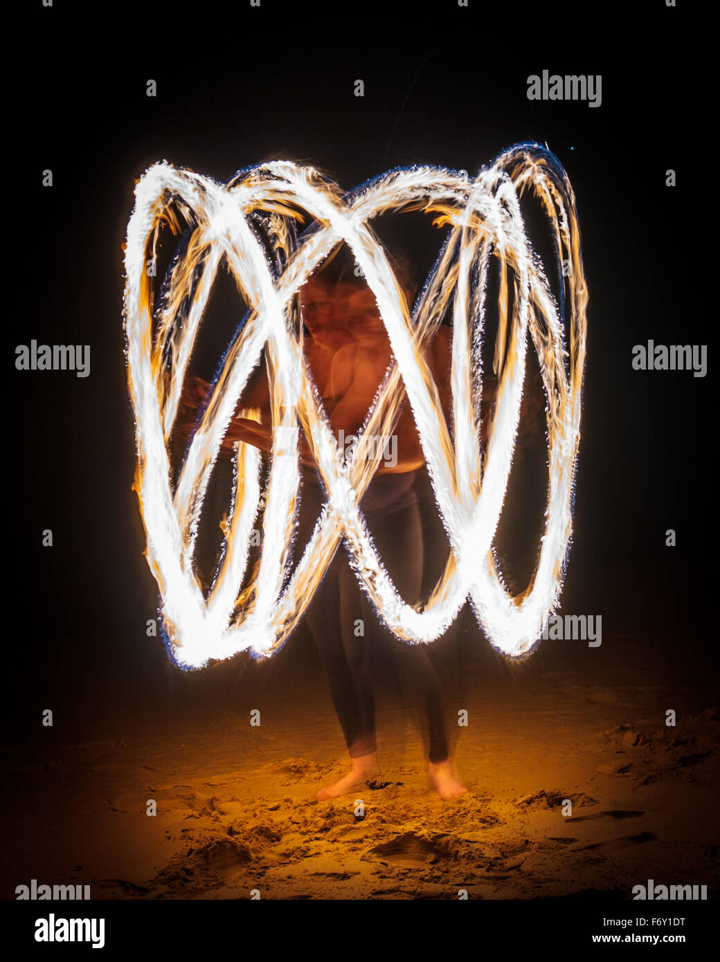 Fire twirling or 'fire poi' performance Stock Photo