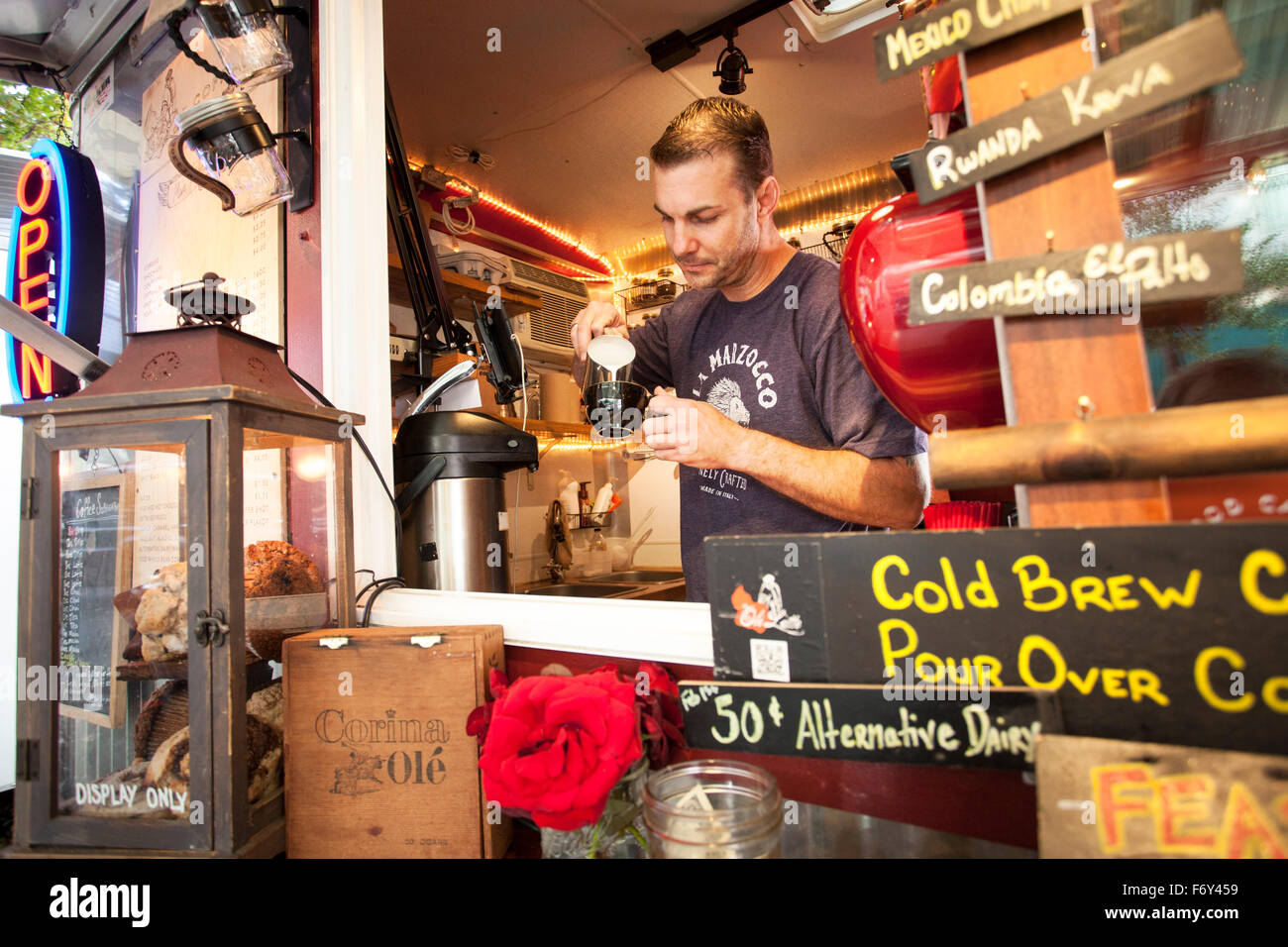 Todd Edwards prepares a latte in his Olé Latte food cart in downtown Portland, Oregon. Stock Photo