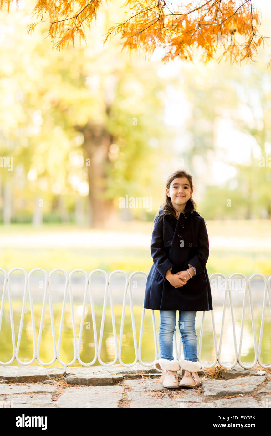 Little girl in the autumn park Stock Photo - Alamy
