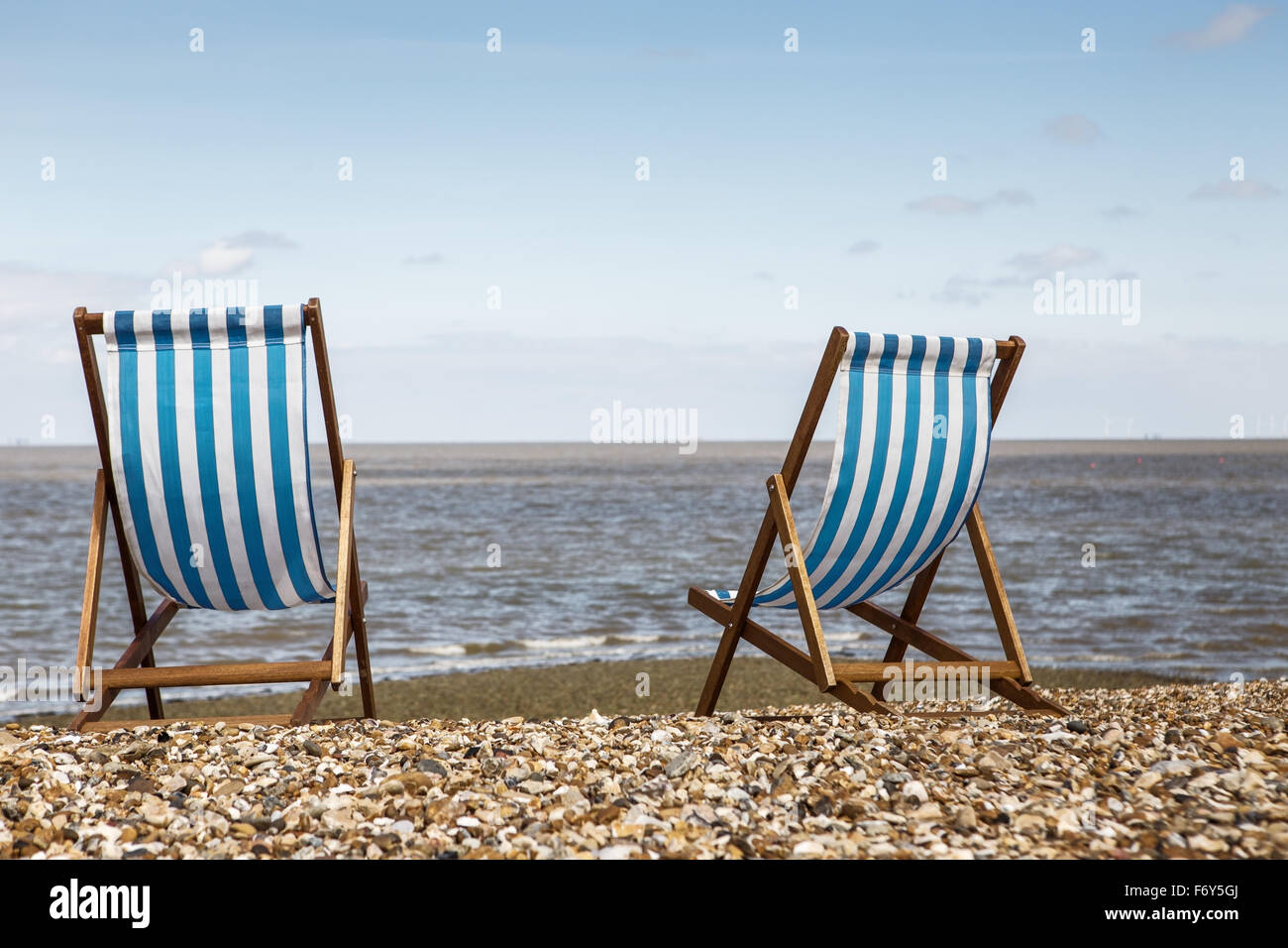 two deck chairs by them self looking out towards the sea Stock Photo ...