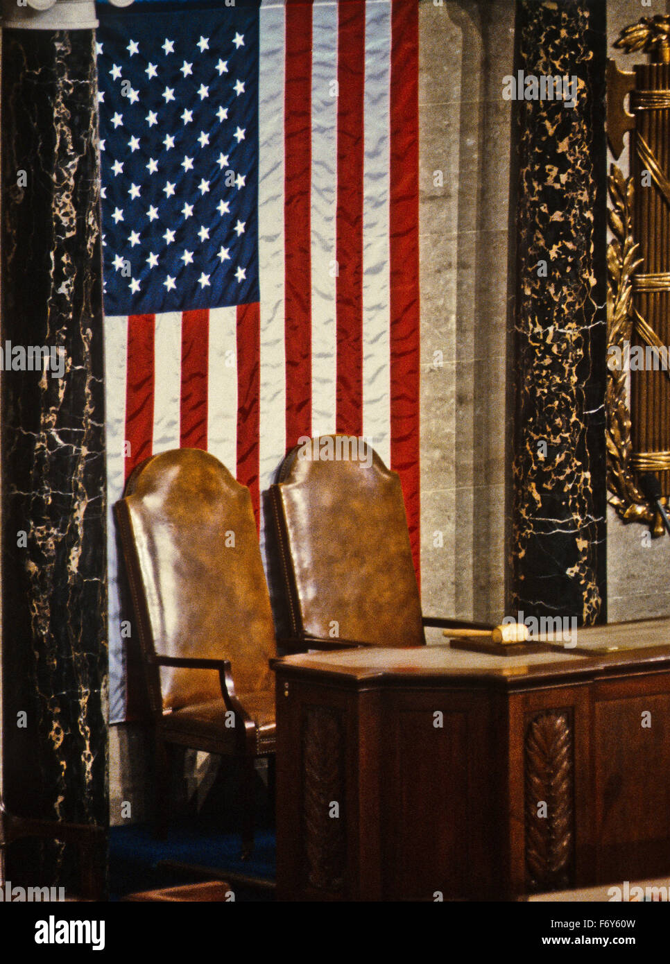 Washington, DC. January, 1992 The American flag hangs behind the empty Speaker of the House and the Vice-President chairs in the The House Chamber, also known as the 'Hall of the House of Representatives.' Legislative activities in the House of Representatives begin and end in the House Chamber. Here, bills are introduced, debated, and voted on. Electoral votes are counted. The Presidents State of the Union address and Joint Sessions and Joint Meeting of the House and Senate are held. Credit: Mark Reinstein Stock Photo