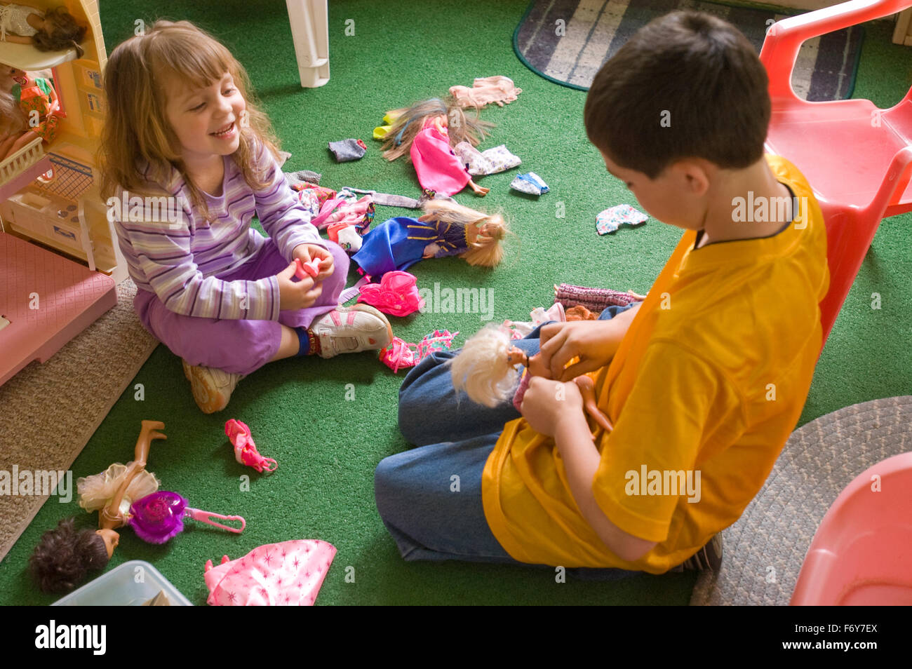 Girl playing with dolls on sale