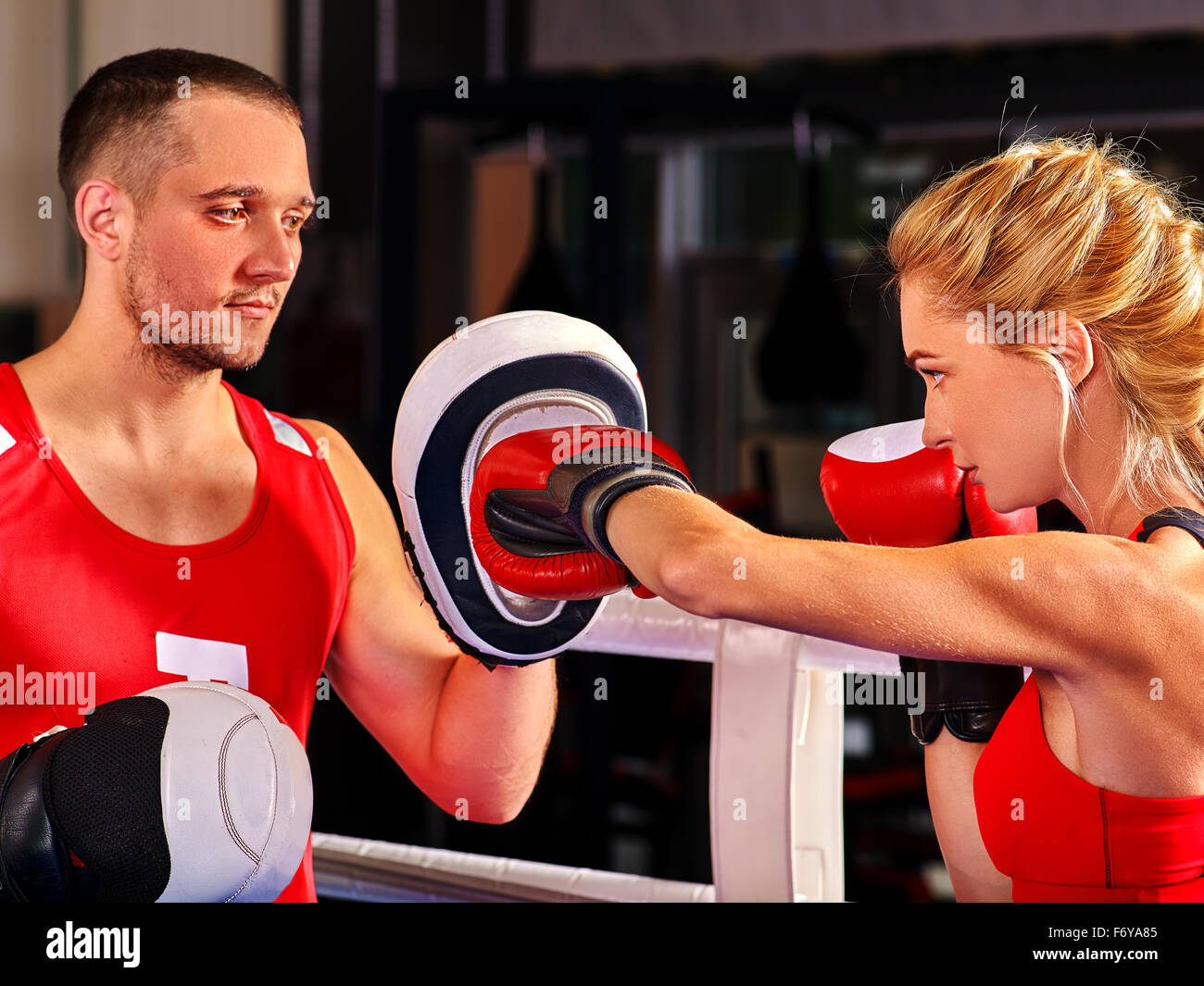 Female boxer throwing right cross at mitts Stock Photo Alamy