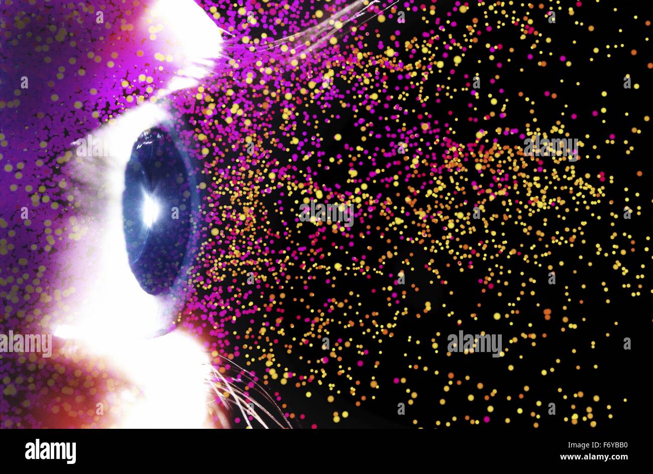 Photograph of a human eye overlaid computer artwork of colourful particles, depicting fantasy, imagination, dreaming, physics, light or stars. Stock Photo