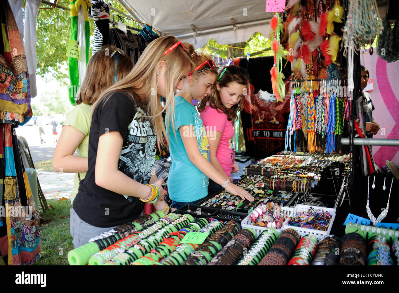 teen girls buying jewelry at festival Stock Photo