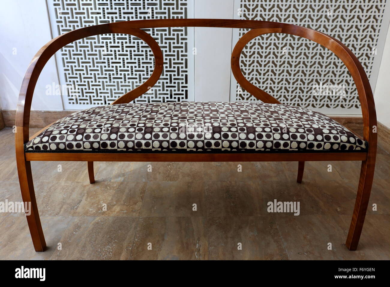 Elegant wooden sofa upholstered in geometrical style, inside the