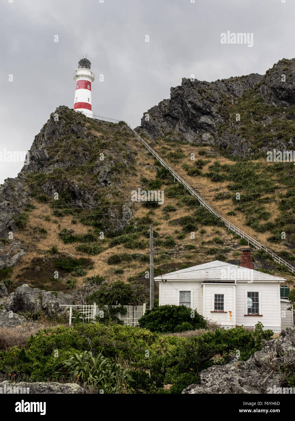 Cape Palliser Lighthouse, the lighthouse keepers house, and the stairsto teh lighthouse Stock Photo