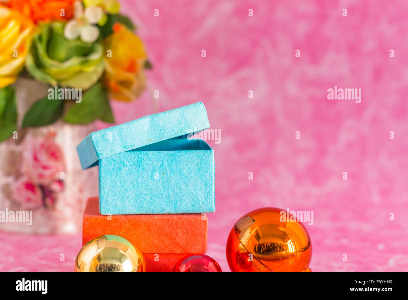 Gift boxes and balls on a pink background. Stock Photo