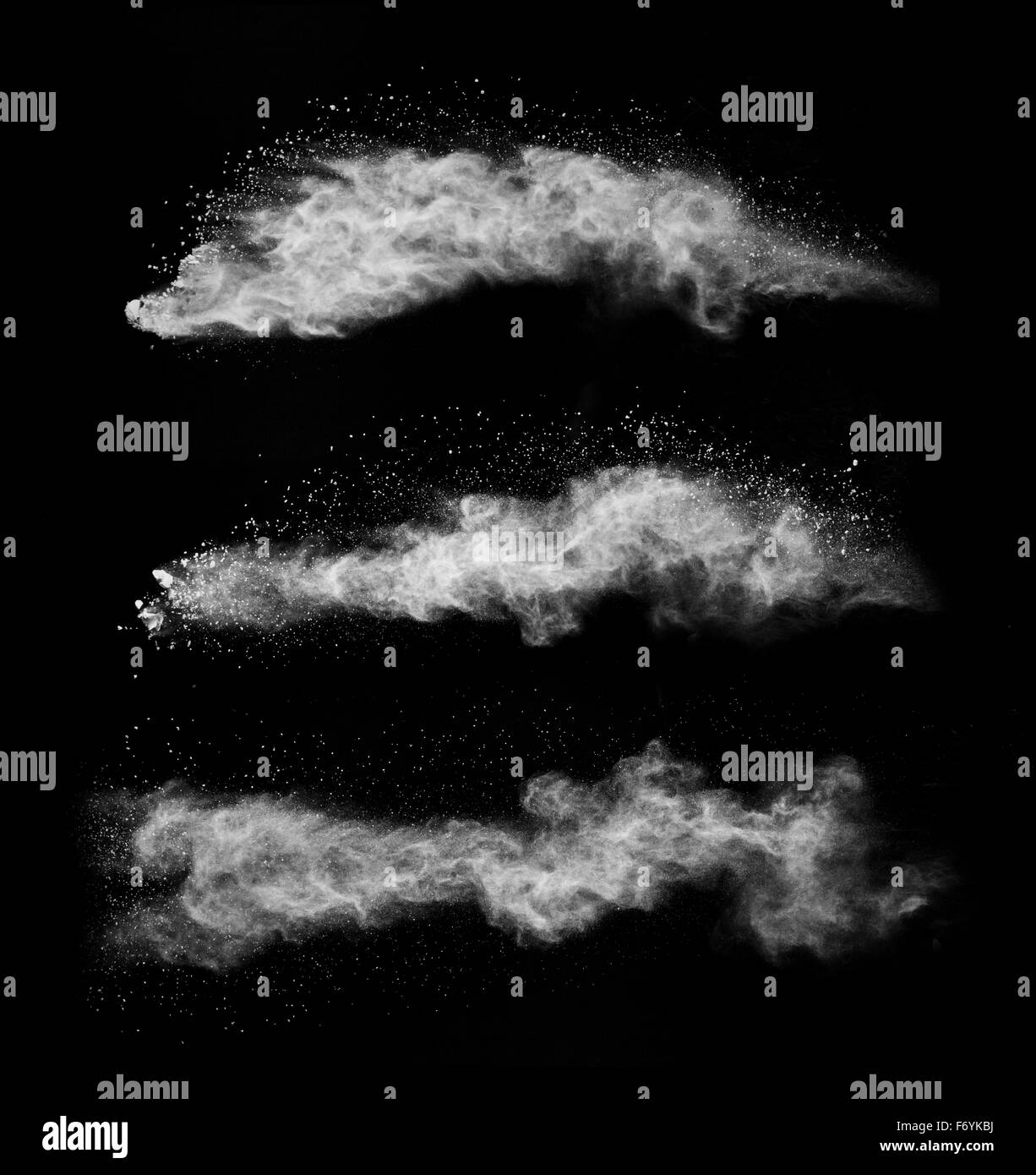 Freeze motion of white dust explosions on black background Stock Photo