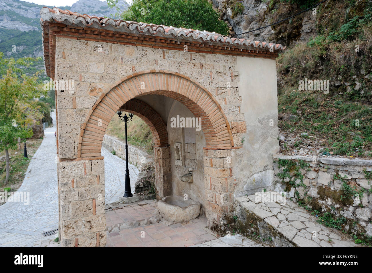 Arched water fountain on the path to The National Skanderbeg Museum, which stands within the walls of Krujë castle, Stock Photo