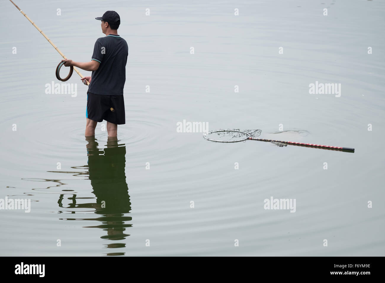 A man fishing in Hanoi, Vietnam West Lake Stock Photo Alamy