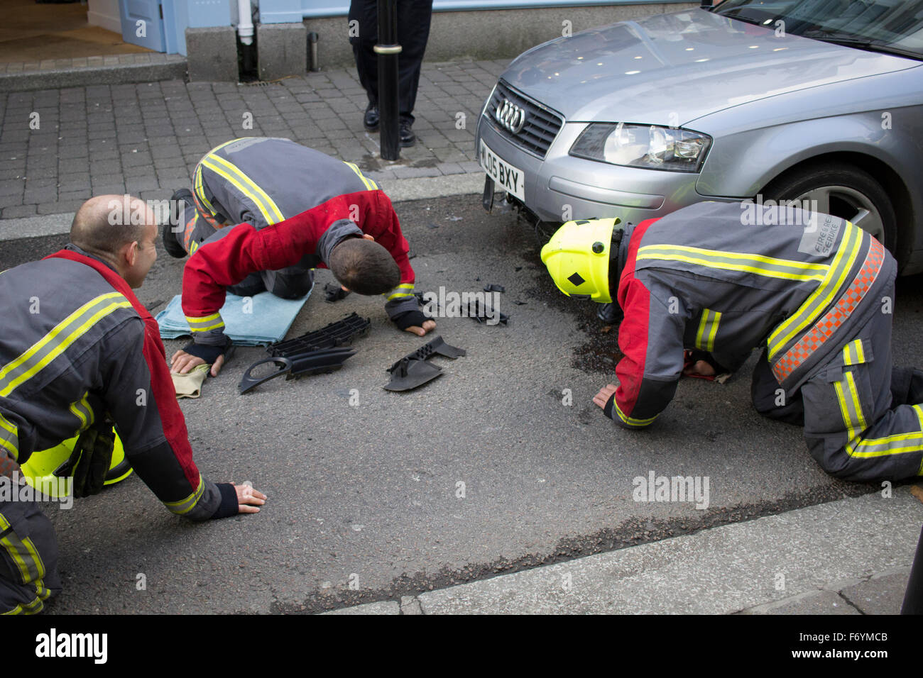 Firemen come to remove a silver Audi impaled on automatic rising bollard in Castle Street, Falmouth. 1st November 2015. Stock Photo