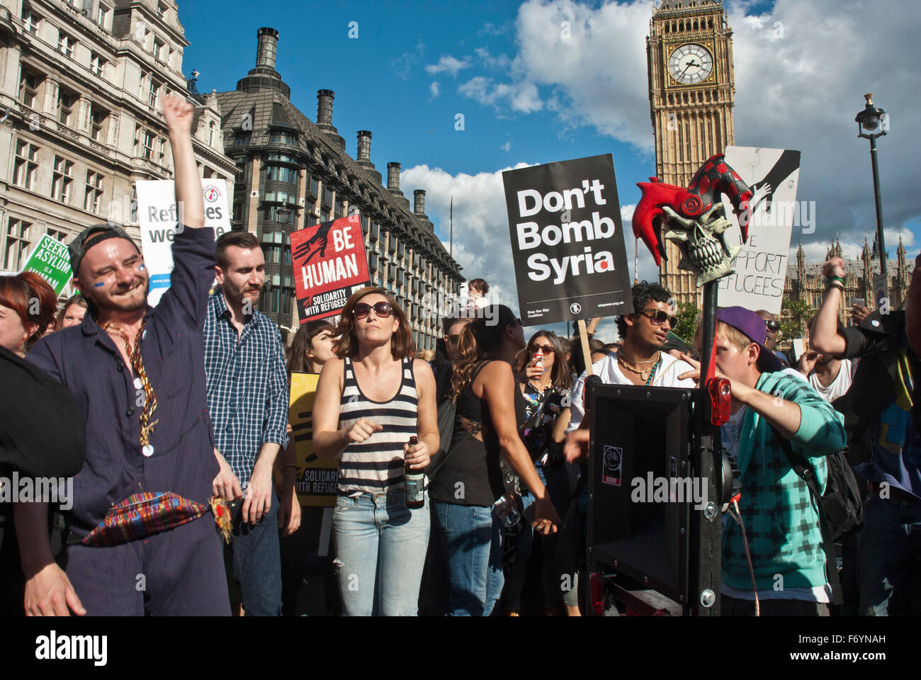 'Refugees welcome here' demonstration. Posters include 'Don't Bomb Syria'. Big Ben in background Stock Photo