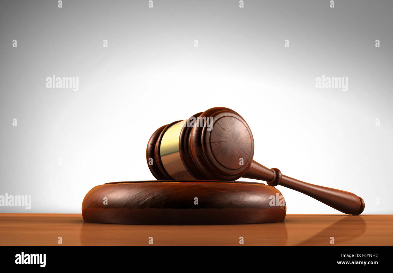 Law, justice and legal system concept with a wooden gavel judge symbol on a desktop. Stock Photo