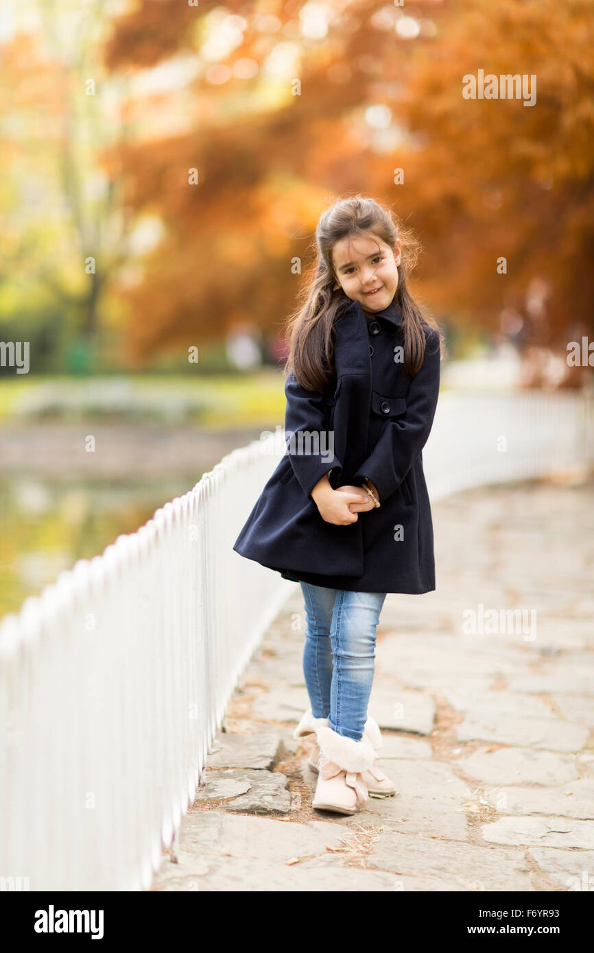 Little girl in the autumn park Stock Photo - Alamy