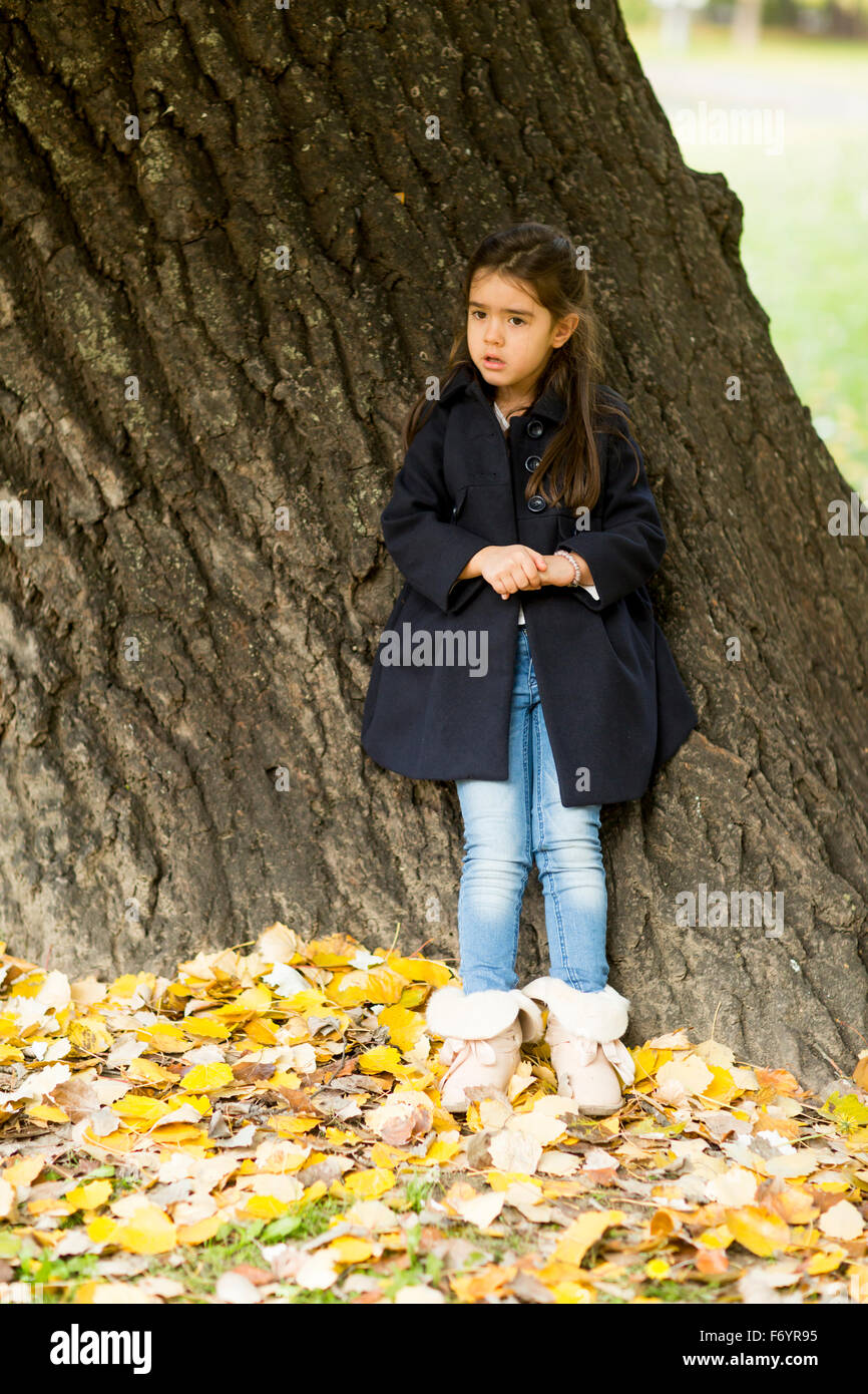 Little girl in the autumn park Stock Photo - Alamy