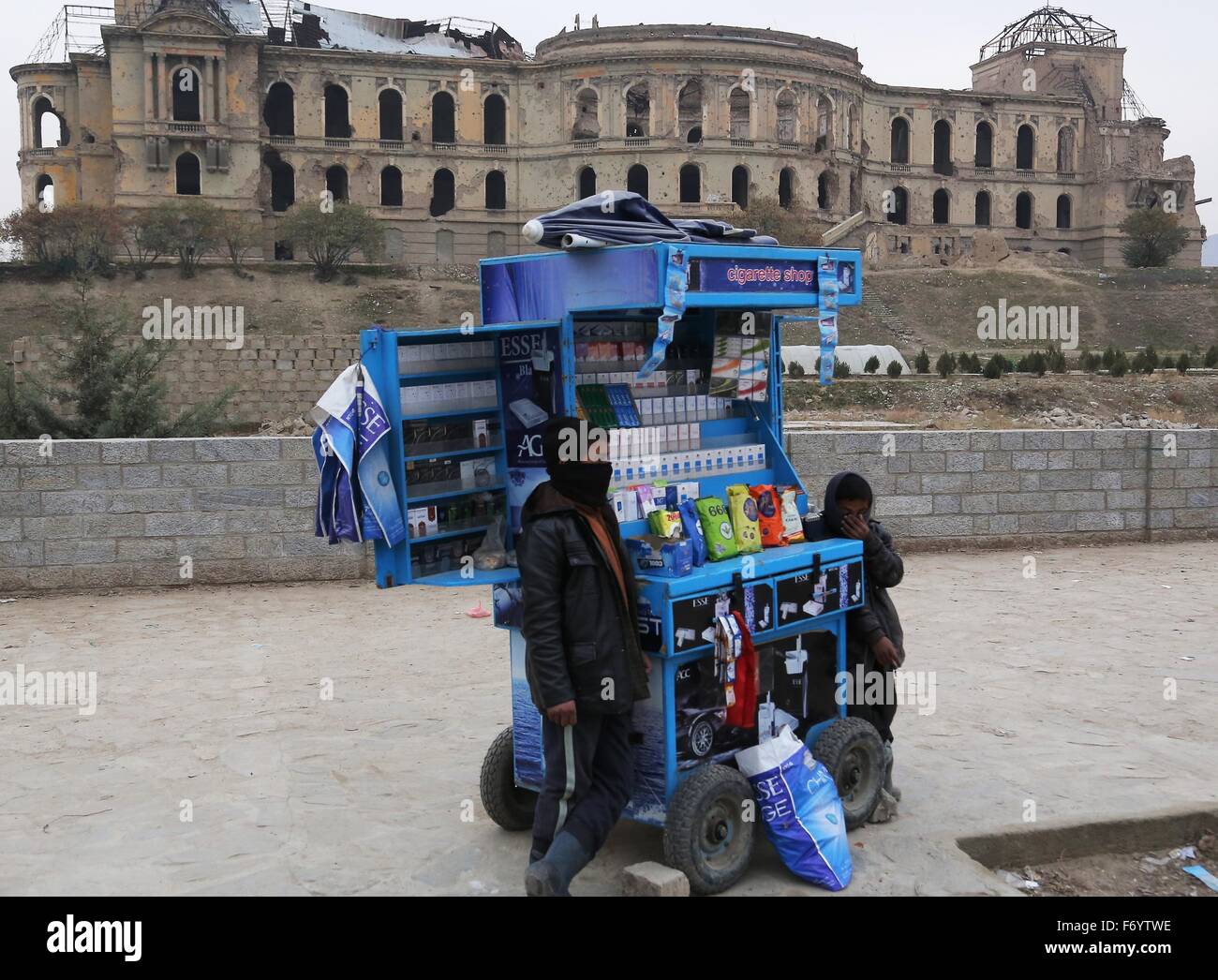 Kabul, Afghanistan. 22nd Nov, 2015. Afghan boys sell cigarettes in front of the Darul Aman Palace, which had been destroyed during the civil war in 1990s, in Kabul, capital of Afghanistan, Nov. 22, 2015. © Rahmat Alizadah/Xinhua/Alamy Live News Stock Photo